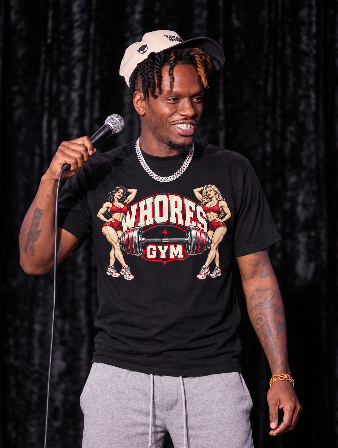 Promotional stage image of comedian Jay Legend wearing the WHORES GYM graphic T-shirt.